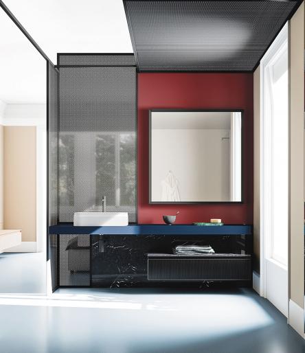 Composizione Absolute 06 di Arbi Arredobagno costituita da piano top in Fenix Bluriva, su cui &egrave; appoggiato il lavabo Belt 55 in tekno, e completata dalla base con fronte in vetro ondulato nero e piano in gres Iris Black Marquinia. Specchiera Naike.